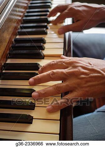 Stock Photograph - "Hands of man playing piano in Providence, Rhode Island, United States. ". Fotosearch