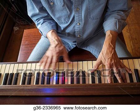 Stock Photography - "Hands of man playing piano in Providence, Rhode Island, United States. ". Fotosearch