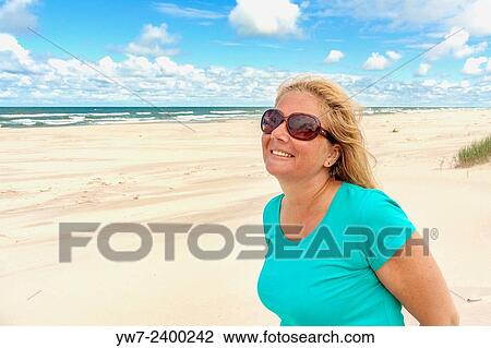 Happy woman on a Baltic sea beach in Poland. View Large Photo Image Stock Image - Happy woman on a Baltic sea beach in Poland.. Fotosearch
