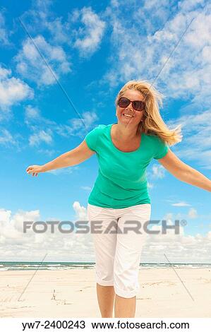 Happy woman on a Baltic sea beach in Poland. View Large Photo Image Stock Image - Happy woman on a Baltic sea beach in Poland.. Fotosearch