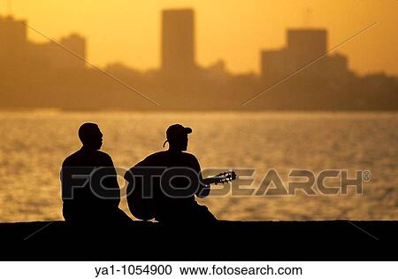 "Local musician playing blues music at Goree island during sunset. Background, capital city Dakar. Senegal, West Africa" View Large Photo Image Stock Image - "Local musician playing blues music at Goree island during sunset. Background, capital city Dakar. Senegal, West Africa". Fotosearch