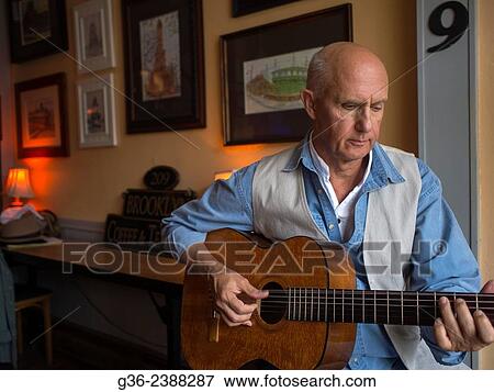 Stock Photo - "Man playing guitar at cafe in Providence, Rhode Island, United States. ". Fotosearch