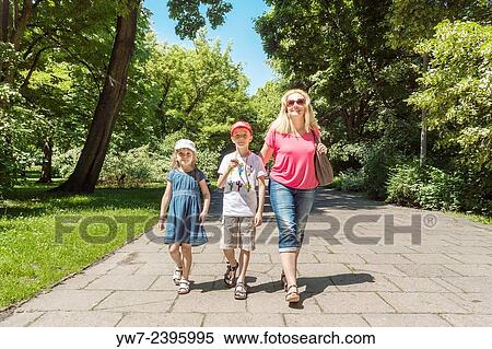"Mother and children having a walk in Praski Park, Warsaw, Poland" View Large Photo Image Stock Photography - "Mother and children having a walk in Praski Park, Warsaw, Poland". Fotosearch