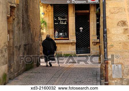 Stock Image - "old woman walking, Sarlat-la-Canéda, Dordogne Department, Aquitaine, France. ". Fotosearch