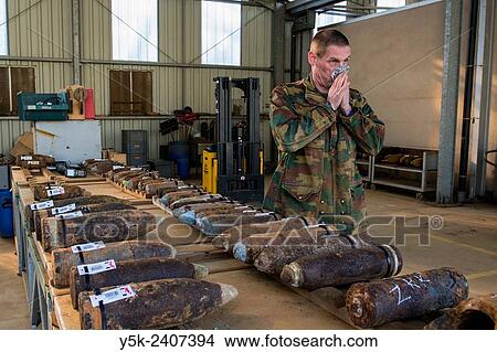 "Poelkapelle, Belgium. Army Battalion for Demolition of Explosives. Army chief corporal working on the identification and classification of recovered live World War 1 shells and munition, prior to demolition. " View Large Photo Image Picture - "Poelkapelle, Belgium. Army Battalion for Demolition of Explosives. Army chief corporal working on the identification and classification of recovered live World War 1 shells and munition, prior to demolition. ". Fotosearch