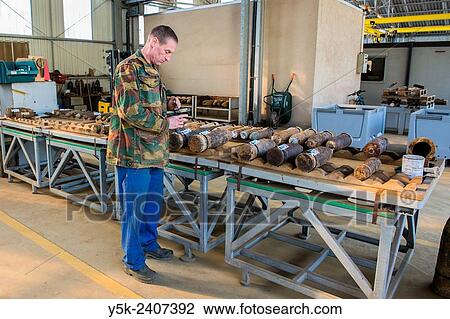 "Poelkapelle, Belgium. Army Battalion for Demolition of Explosives. Army chief corporal working on the identification and classification of recovered live World War 1 shells and munition, prior to demolition. " View Large Photo Image Stock Image - "Poelkapelle, Belgium. Army Battalion for Demolition of Explosives. Army chief corporal working on the identification and classification of recovered live World War 1 shells and munition, prior to demolition. ". Fotosearch