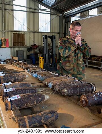 Stock Photography - "Poelkapelle, Belgium. Army Battalion for Demolition of Explosives. Army chief corporal working on the identification and classification of recovered live World War 1 shells and munition, prior to demolition. ". Fotosearch