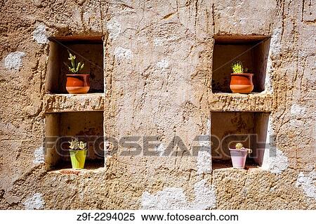 "Potted cactus in holes in an old loft, Segovia, Spain. " View Large Photo Image Stock Photography - "Potted cactus in holes in an old loft, Segovia, Spain. ". Fotosearch
