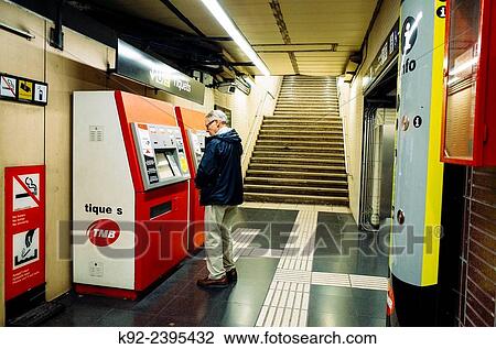 Stock Image - "Senior man getting tickets in a subway station in Barcelona, Spain". Fotosearch