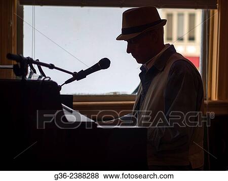 Stock Photo - "Silhouette of man playing piano in Providence, Rhode Island, United States. ". Fotosearch