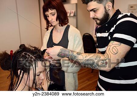 Student hairstylists working on rope braiding hair of a model in a salon. View Large Photo Image Stock Photo - Student hairstylists working on rope braiding hair of a model in a salon.. Fotosearch