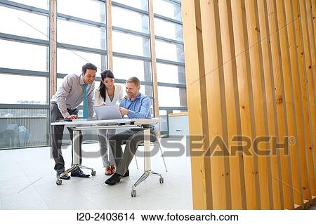 Three executives looking at computer View Large Photo Image Picture - Three executives looking at computer. Fotosearch