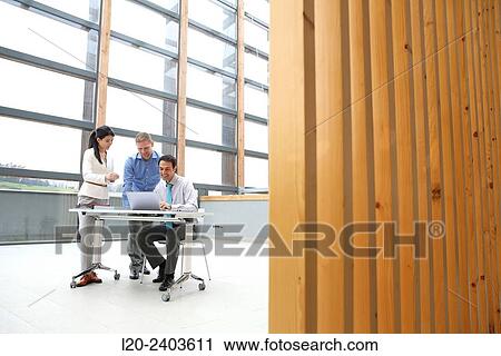 Three executives looking at computer View Large Photo Image Stock Image - Three executives looking at computer. Fotosearch
