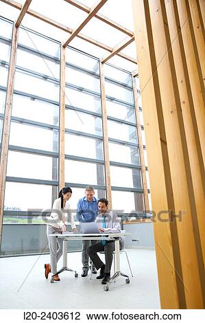 Three executives looking at computer View Large Photo Image Stock Image - Three executives looking at computer. Fotosearch