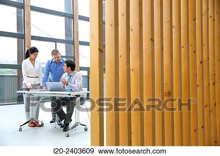 Three executives looking at computer View Large Photo Image Stock Photo - Three executives looking at computer. Fotosearch