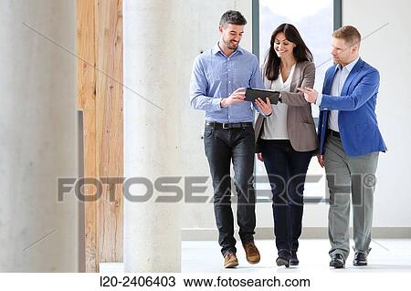 Three executives looking at tablet View Large Photo Image Stock Image - Three executives looking at tablet. Fotosearch