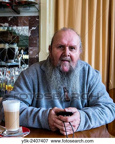 "Tilburg, Netherlands. The 67 year old Kees, sitting at his regular spot at the bar of Grand Cafe Spaarbank, while having a large cup of Coffee Latte. " View Large Photo Image Stock Photo - "Tilburg, Netherlands. The 67 year old Kees, sitting at his regular spot at the bar of Grand Cafe Spaarbank, while having a large cup of Coffee Latte. ". Fotosearch