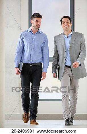 Stock Image - Two executives walking. Fotosearch