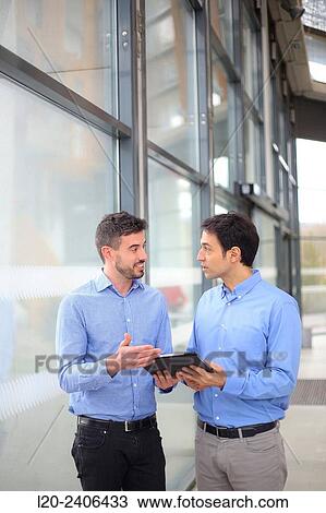 Two executives with digital tablet View Large Photo Image Stock Image - Two executives with digital tablet. Fotosearch