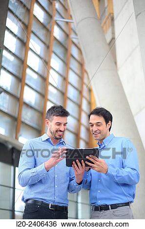 Two executives with digital tablet View Large Photo Image Stock Photograph - Two executives with digital tablet. Fotosearch