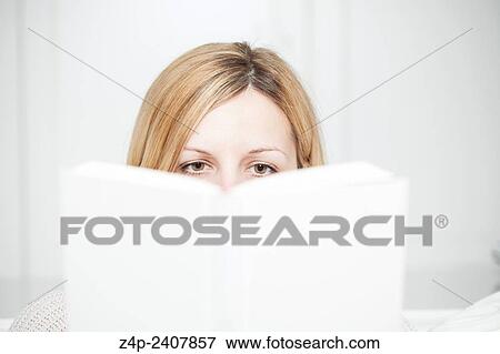 Stock Photo - woman attentively reads a book.. Fotosearch
