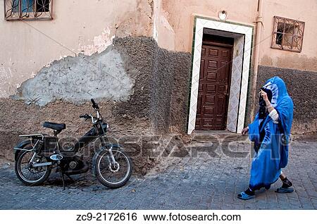 "Woman in traditional cothing walking on the streets of the ancient medina, Tiznit, Morocco. " View Large Photo Image Stock Photograph - "Woman in traditional cothing walking on the streets of the ancient medina, Tiznit, Morocco. ". Fotosearch