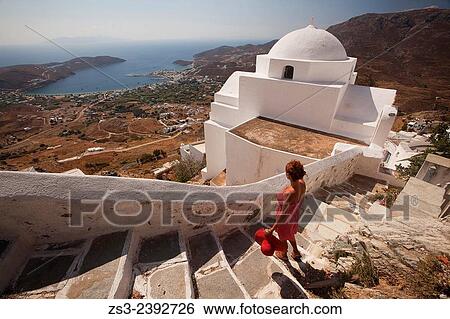 "Woman looking down to the port from the stairs of a church in Hora, Serifos, Cyclades Islands, Greek Islands, Greece, Europe. " View Large Photo Image Stock Photograph - "Woman looking down to the port from the stairs of a church in Hora, Serifos, Cyclades Islands, Greek Islands, Greece, Europe. ". Fotosearch