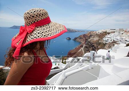 "Woman sitting near a hotel entrance by the cliff in Oia town, Santorini, Cyclades Islands, Greek Islands, Greece, Europe. " View Large Photo Image Stock Photo - "Woman sitting near a hotel entrance by the cliff in Oia town, Santorini, Cyclades Islands, Greek Islands, Greece, Europe. ". Fotosearch