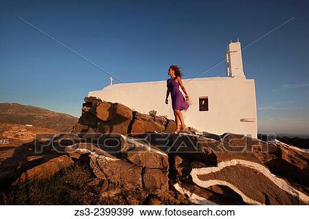 "Woman standing in front of a chapel at the top of the hill in Chora, Ios, Cyclades Islands, Greek Islands, Greece, Europe. " View Large Photo Image Stock Photo - "Woman standing in front of a chapel at the top of the hill in Chora, Ios, Cyclades Islands, Greek Islands, Greece, Europe. ". Fotosearch