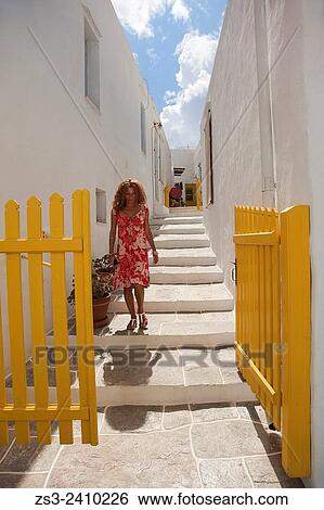 "Woman walking in the alleys of town, Apollonia village, Sifnos, Cyclades Islands, Greek Islands, Greece, Turkey. " View Large Photo Image Stock Photograph - "Woman walking in the alleys of town, Apollonia village, Sifnos, Cyclades Islands, Greek Islands, Greece, Turkey. ". Fotosearch