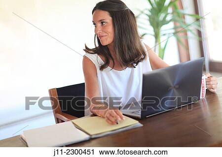 Stock Image - Woman working with laptop. Fotosearch