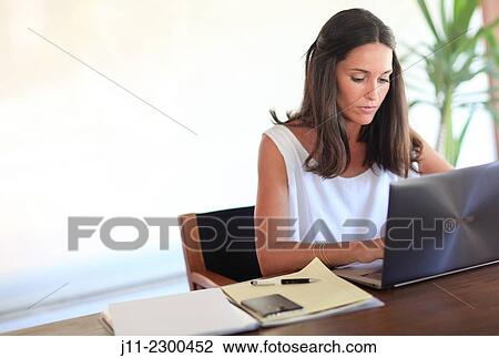 Woman working with laptop View Large Photo Image Stock Image - Woman working with laptop. Fotosearch