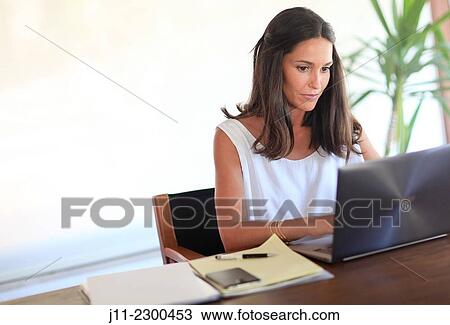 Woman working with laptop View Large Photo Image Stock Image - Woman working with laptop. Fotosearch