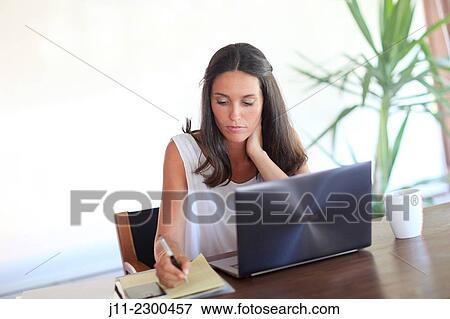 Stock Photo - Woman working with laptop. Fotosearch