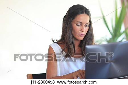 Woman working with laptop View Large Photo Image Stock Photo - Woman working with laptop. Fotosearch