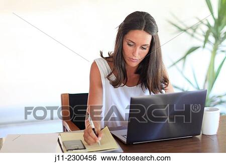 Woman working with laptop View Large Photo Image Stock Photograph - Woman working with laptop. Fotosearch