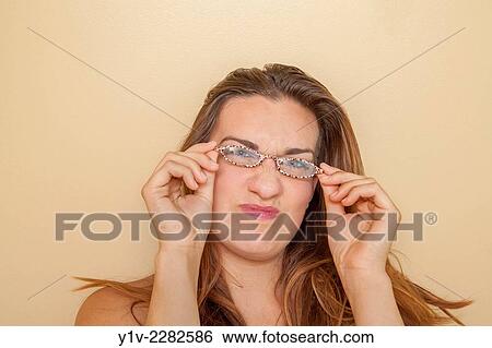 Stock Photograph - Young woman wearing glasses.. Fotosearch