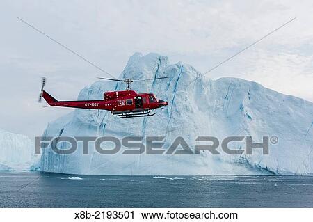 A commercial helicopter flight amongst huge icebergs calved from the Ilulissat Glacier, a UNESCO World Heritage Site, Ilulissat, Greenland. View Large Photo Image Stock Image - A commercial helicopter flight amongst huge icebergs calved from the Ilulissat Glacier, a UNESCO World Heritage Site, Ilulissat, Greenland.. Fotosearch