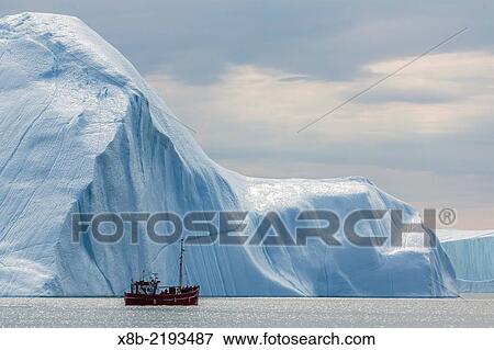 A commercial iceberg tour amongst huge icebergs calved from the Ilulissat Glacier, a UNESCO World Heritage Site, Ilulissat, Greenland. View Large Photo Image Stock Photo - A commercial iceberg tour amongst huge icebergs calved from the Ilulissat Glacier, a UNESCO World Heritage Site, Ilulissat, Greenland.. Fotosearch