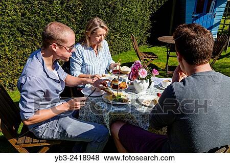 Stock Photo - A Family Enjoy A Traditional English Afternoon Tea, Glynde, Sussex, UK.. Fotosearch