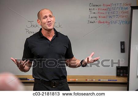 Stock Image - A motivational speaker lectures at a MenÂ´s Career Workshop on new business attire from Working Wardrobes, a organization helping the unemployed dress and groom for successful business job interviews in Southern California. MODEL RELEASE.. Fotosearch