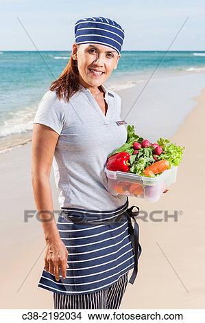 Picture - Asian catering chefs at the beach cooking with a Koththu station. Gold Coast, Queensland, Australia.. Fotosearch