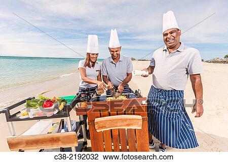 Stock Image - Asian catering chefs at the beach cooking with a Koththu station. Gold Coast, Queensland, Australia.. Fotosearch
