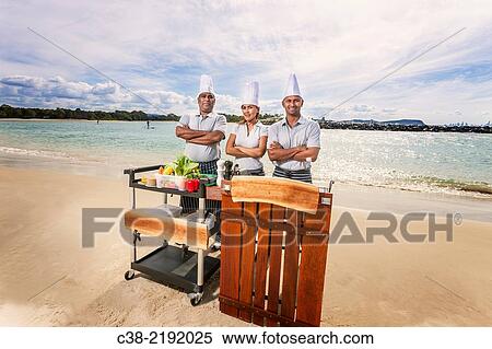 Stock Photography - Asian catering chefs at the beach cooking with a Koththu station. Gold Coast, Queensland, Australia.. Fotosearch