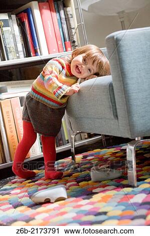 Baby girl, 20 months, pullover, skirt, Knitwear, tigths, Barefoot, shoes, bookshelves, Armchair, brush, carpet View Large Photo Image Stock Image - Baby girl, 20 months, pullover, skirt, Knitwear, tigths, Barefoot, shoes, bookshelves, Armchair, brush, carpet. Fotosearch