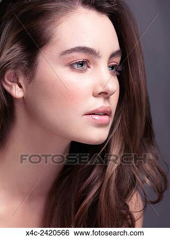 Beauty Portrait Of A Young Woman With Gray Eyes And Long Light