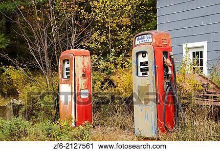 Stock Image - Bethel Maine foliage old ancient gas pumps in fall leaves in Northern New England fall foliage leaf peeping October.. Fotosearch