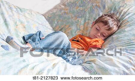 Stock Image - boy sleeping on couch. Fotosearch