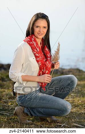 Close-up of a good looking young woman on a beach at a sunny day in early spring. View Large Photo Image Stock Image - Close-up of a good looking young woman on a beach at a sunny day in early spring.. Fotosearch