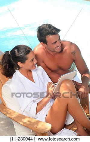 Stock Image - Couple by the pool. Fotosearch